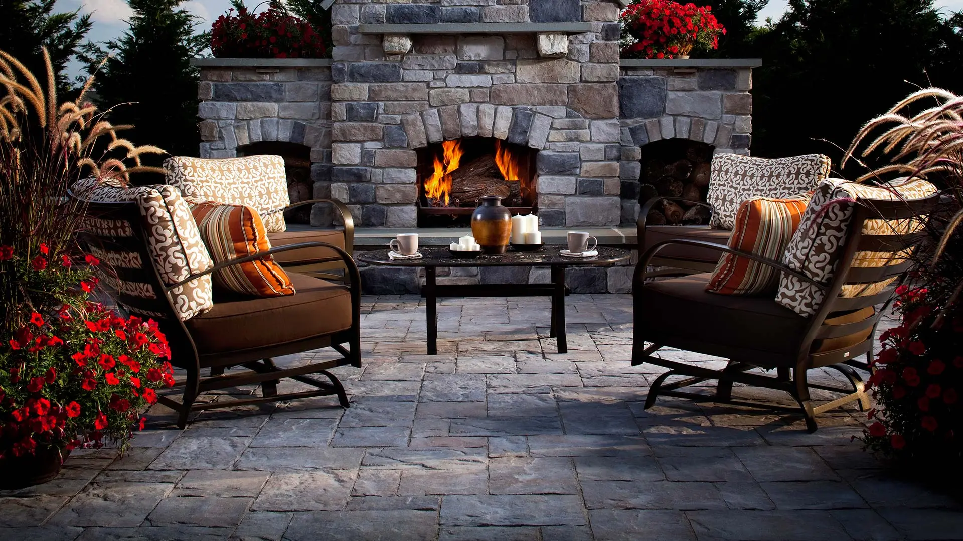 Outdoor fireplace and a paver patio at a luxury home.