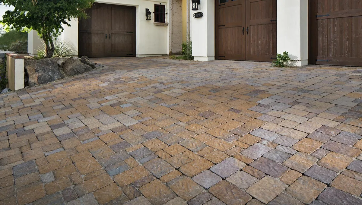 Custom paver driveway installation using earth-toned pavers.
