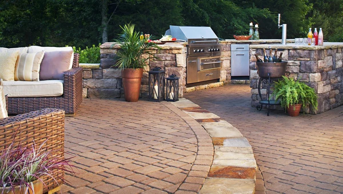 Multi-level paver patio with a custom outdoor kitchen installation.